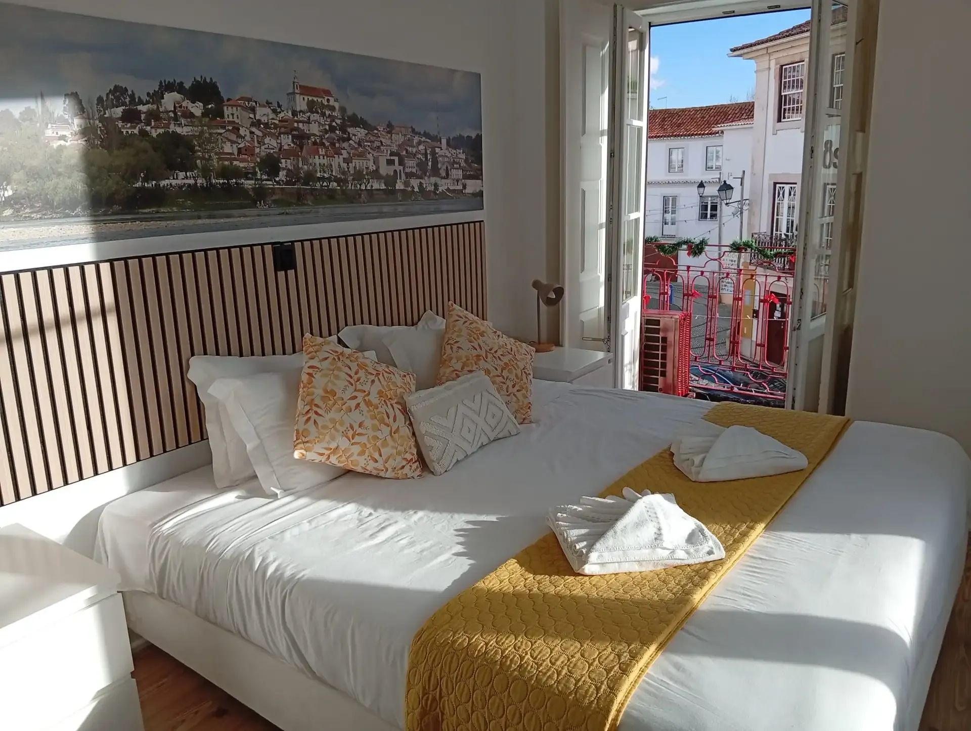Double room — king-size bed with the Constância panel and the balcony open