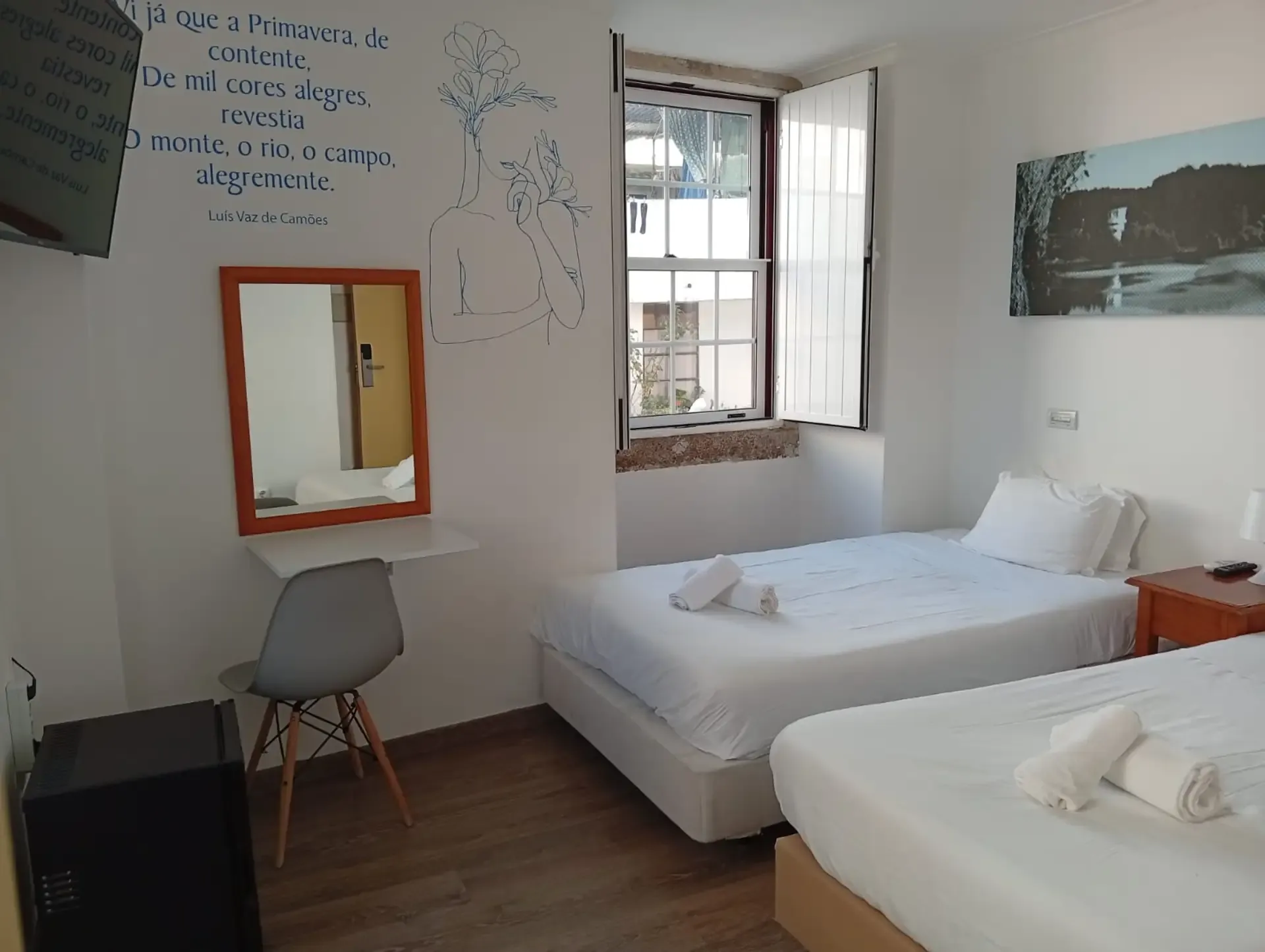 Double or Twin room — two beds, Camões verse painted in blue and an orange mirror